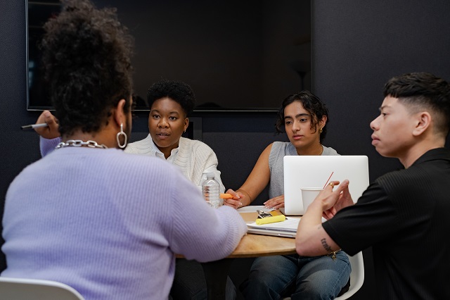 A group of co-workers of varying genders having a meeting