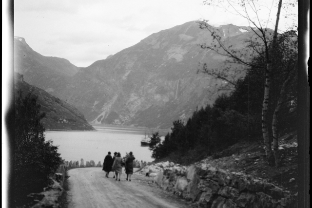 historic black and white photo of 3 women walking down a road