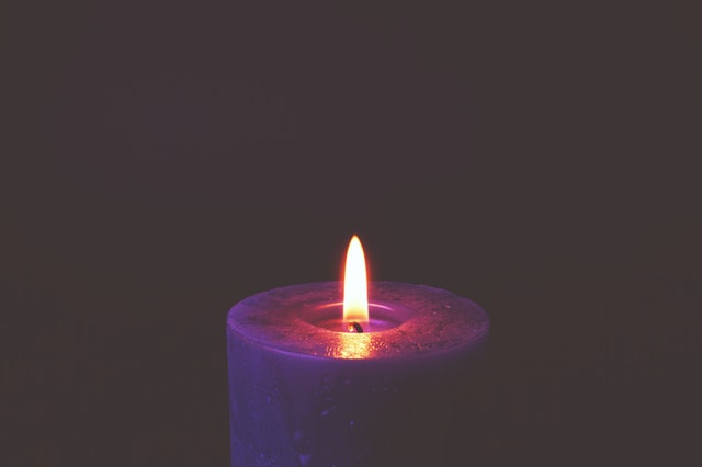 purple candle that is lit