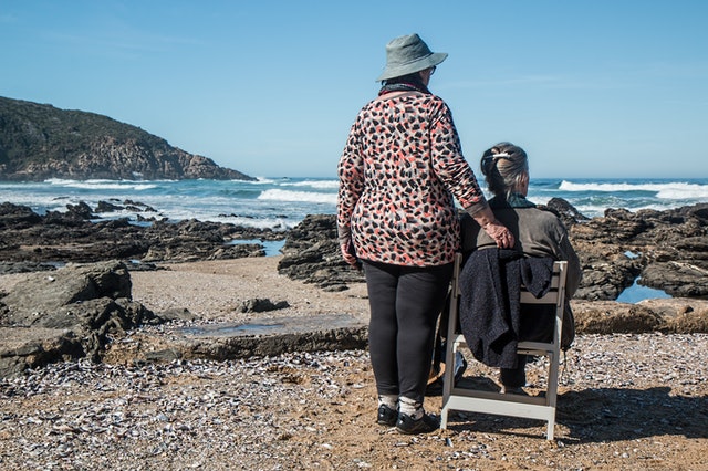 two older women looking at the ocean