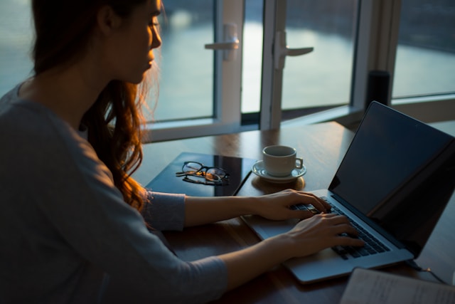 photo of a women looking at a laptop